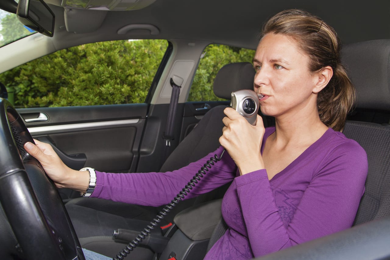 woman taking breathalyzer